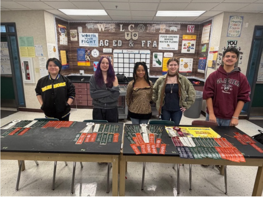 Four FFA students smiling for a photo