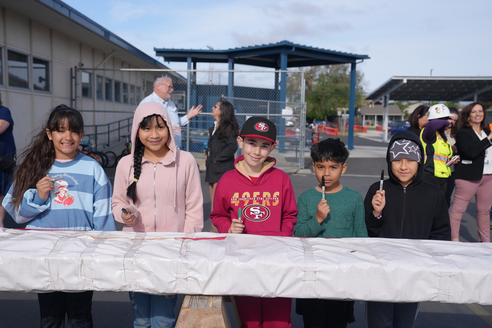 Kids smiling at Anna Kyle's Beam Signing Ceremony