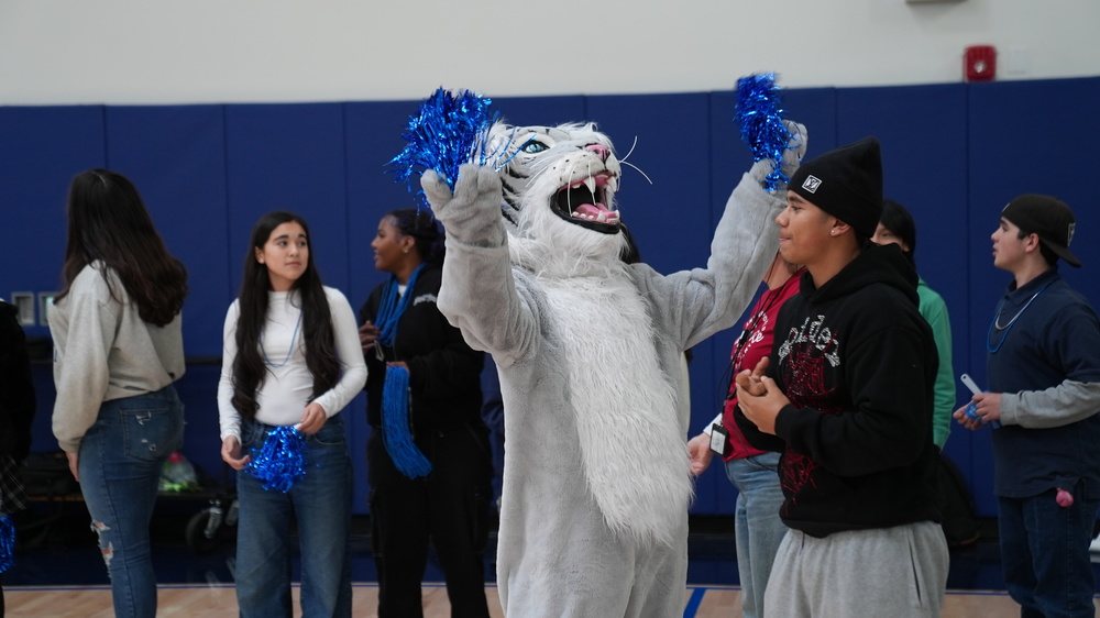 B. Gale Wilson Mascot cheering during Rally in newly built gymnasium with kids around.