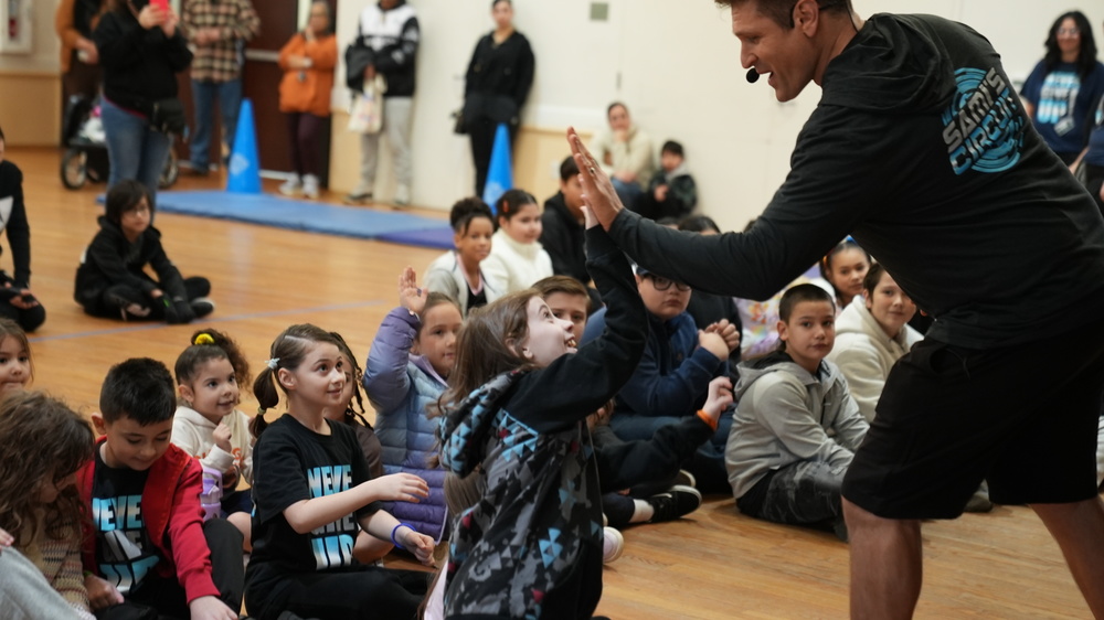 A kid doing high five with fitness instructor Sami