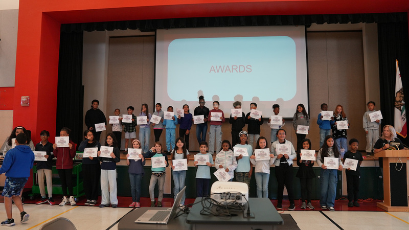 Kids holding their awards