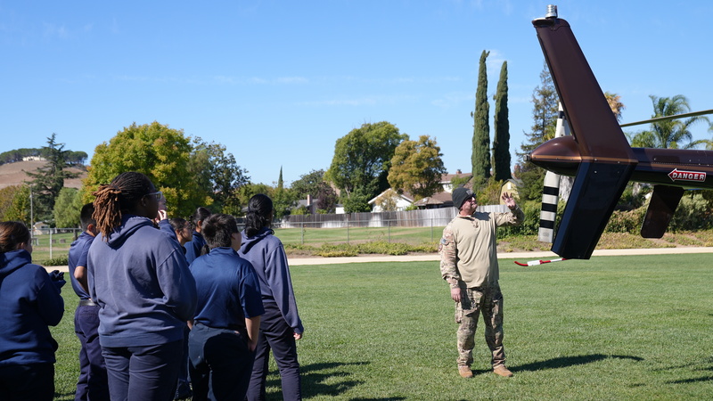 The commander teaching the PSA kids about the helicopter