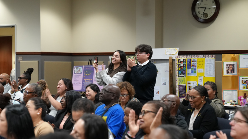A group of kids celebrating their parentsin the audience at the PLTI graduation