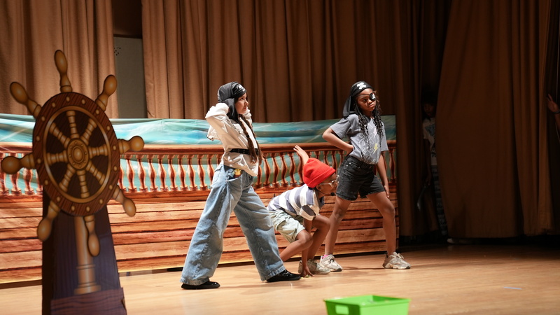 Two students performing for the Peter Pan Production o stage at Dan O Root school