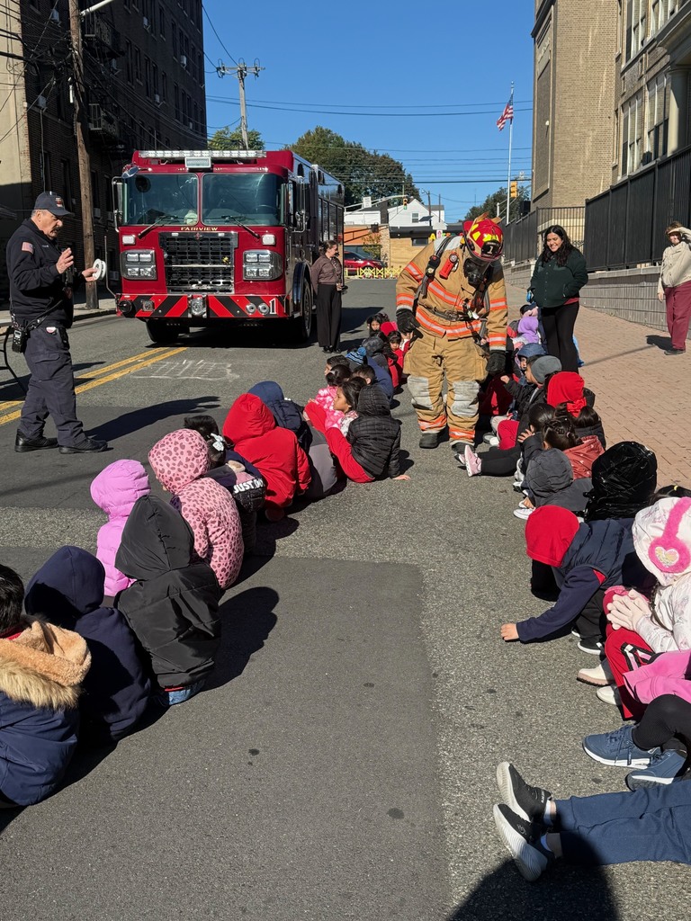 One of our Fairview Firefighters showing the students his gear so they are not afraid of firemen in an emergency.