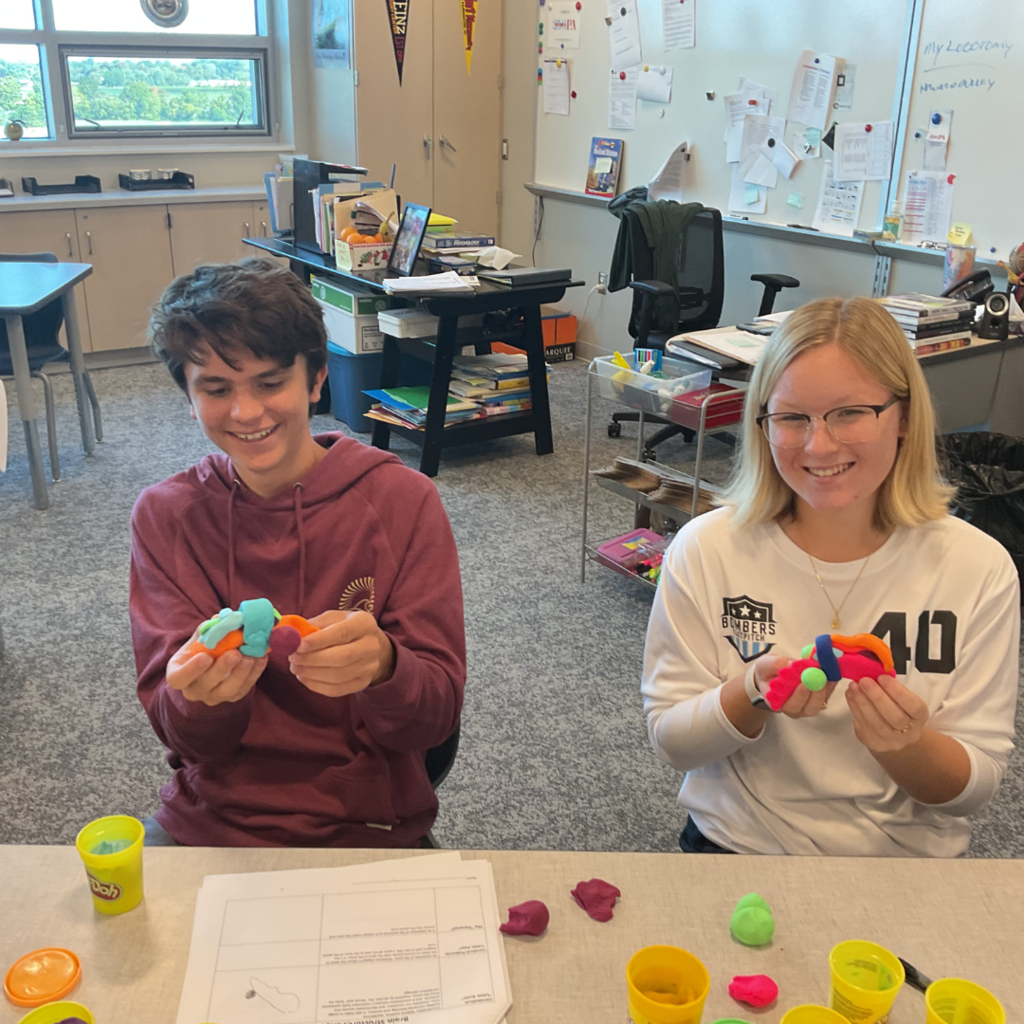 Two students making Play-Doh brains