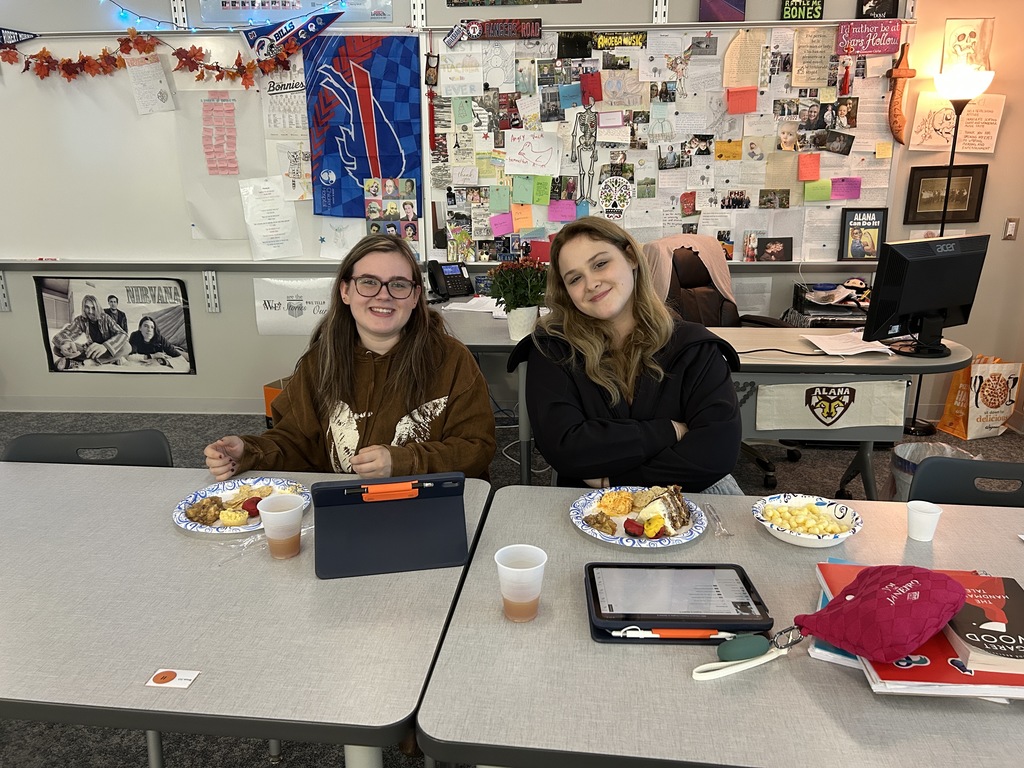 2 students with plates of food smiling