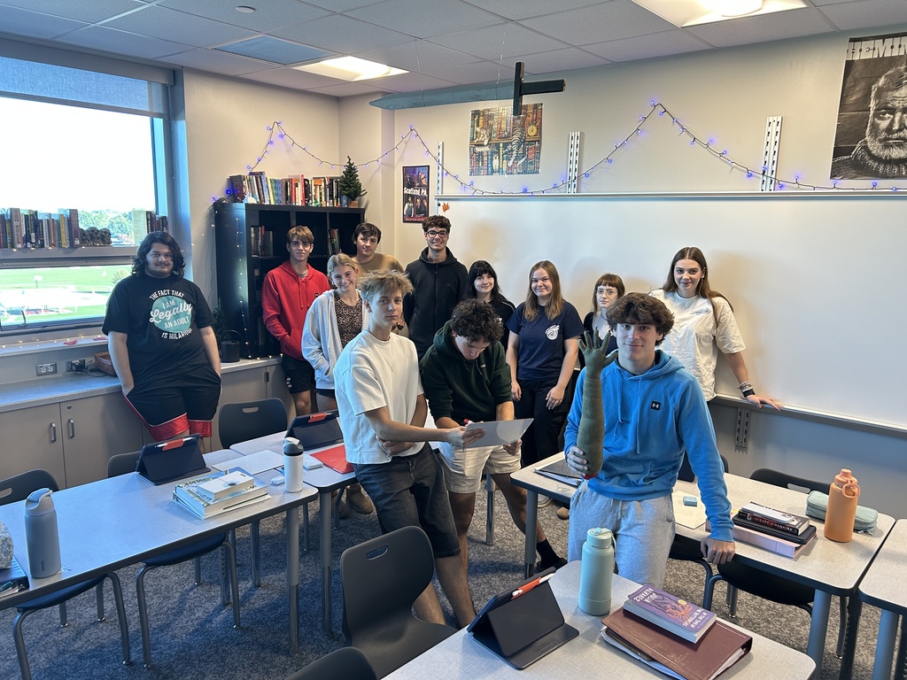 class of students smiling in decorated room