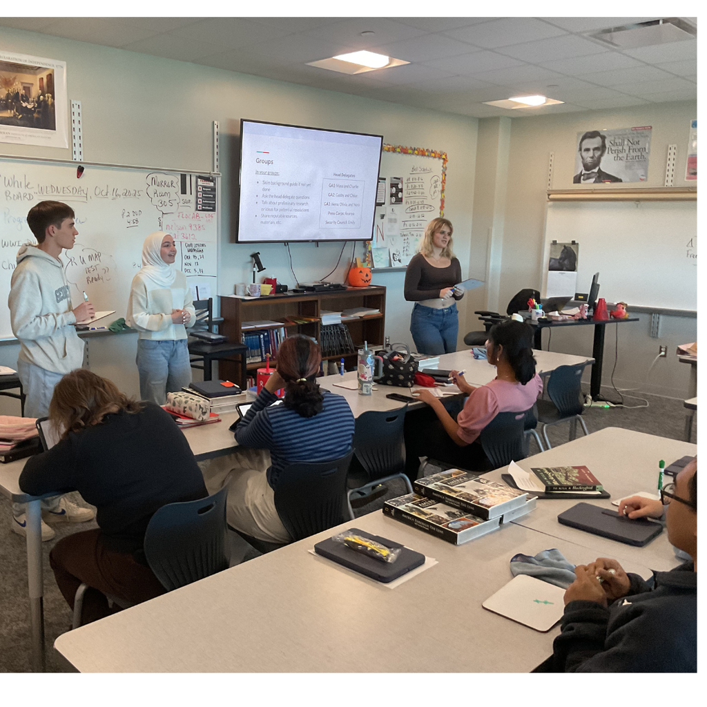 3 students presenting to a class