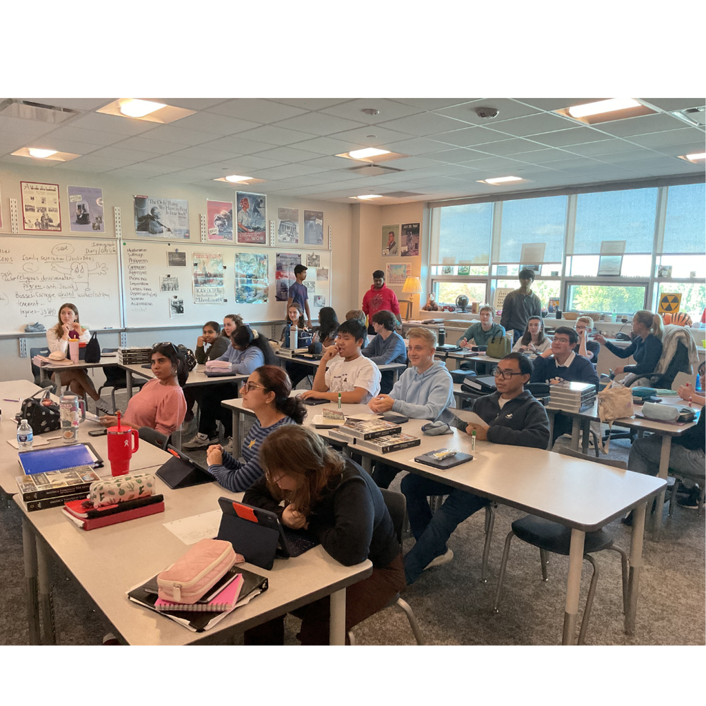 students sitting in a class listening to a presenter