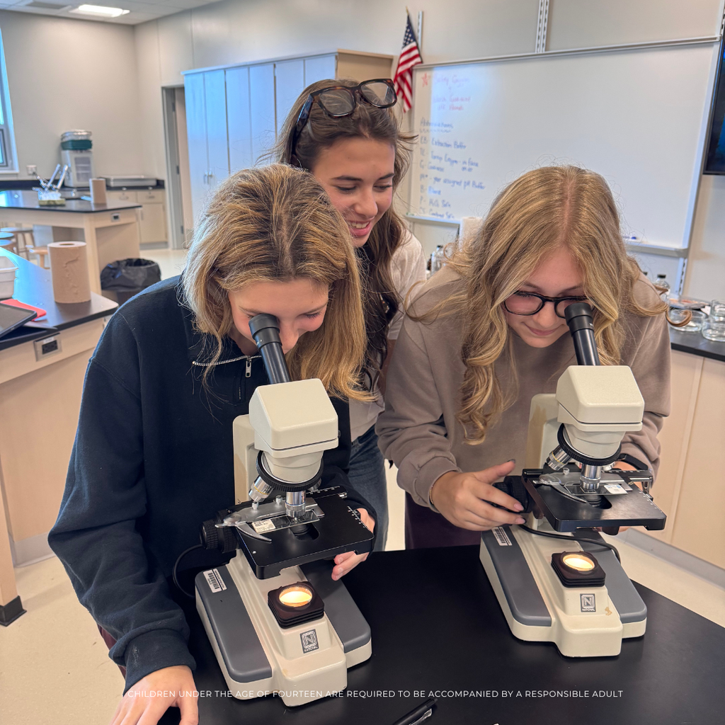 2 students looking through a microscope