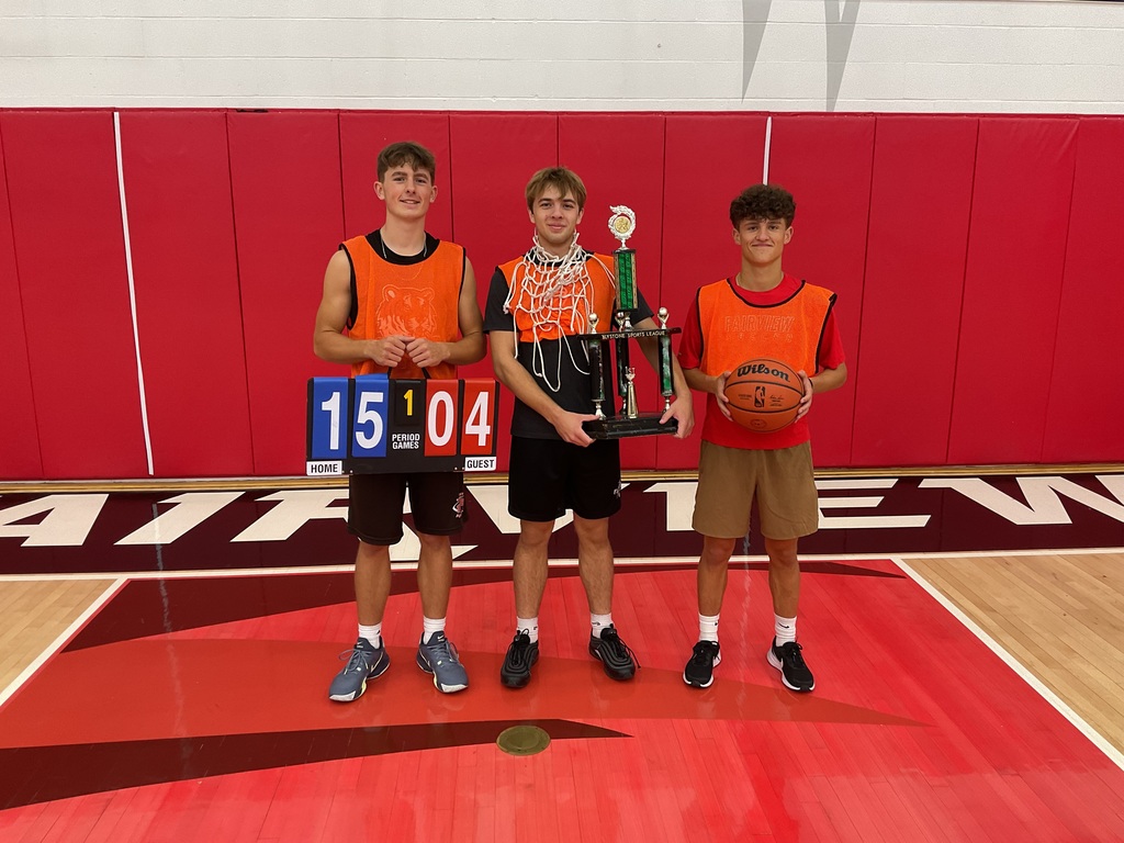 3 students standing with winning trophy