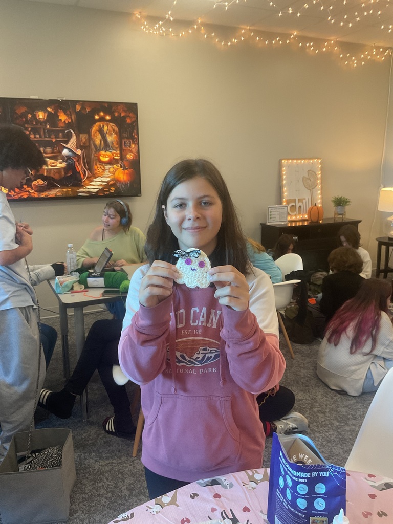 student holding crochet ghost