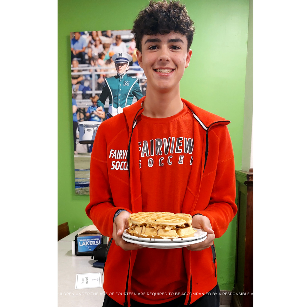 student holding a waffle sandwich