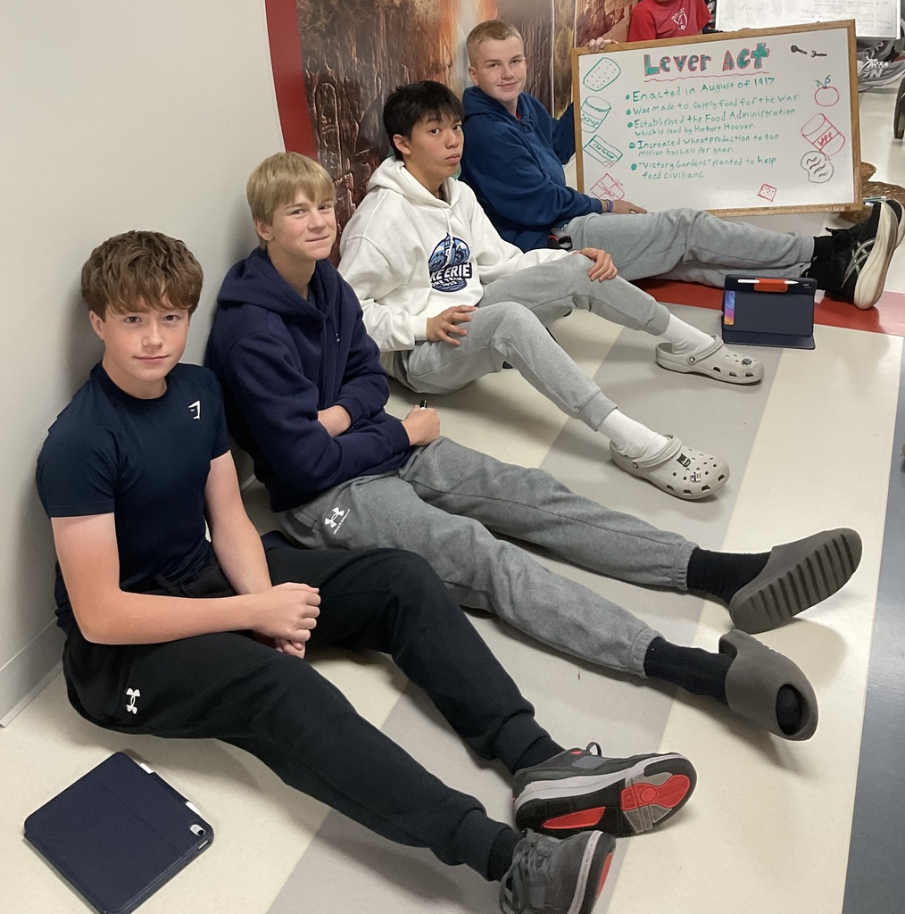 4 students holding a board about lever acts