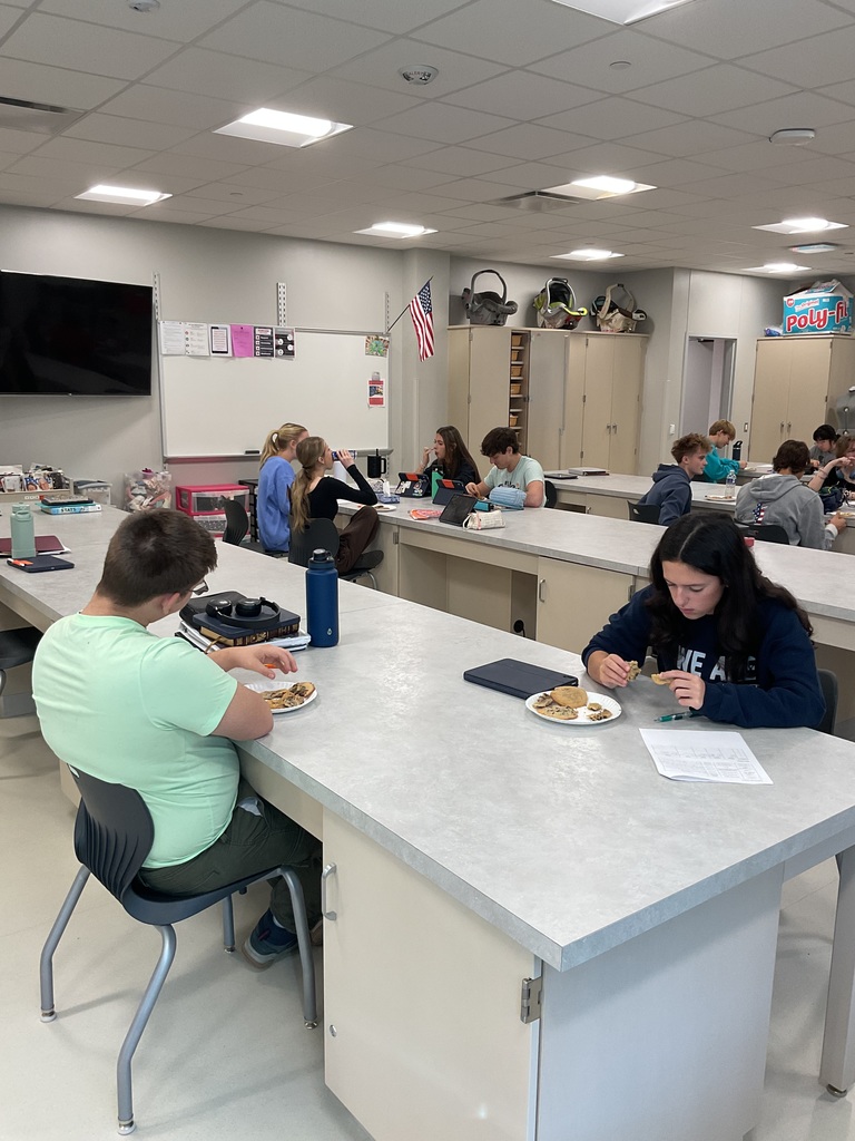 students sitting at tables trying cookies