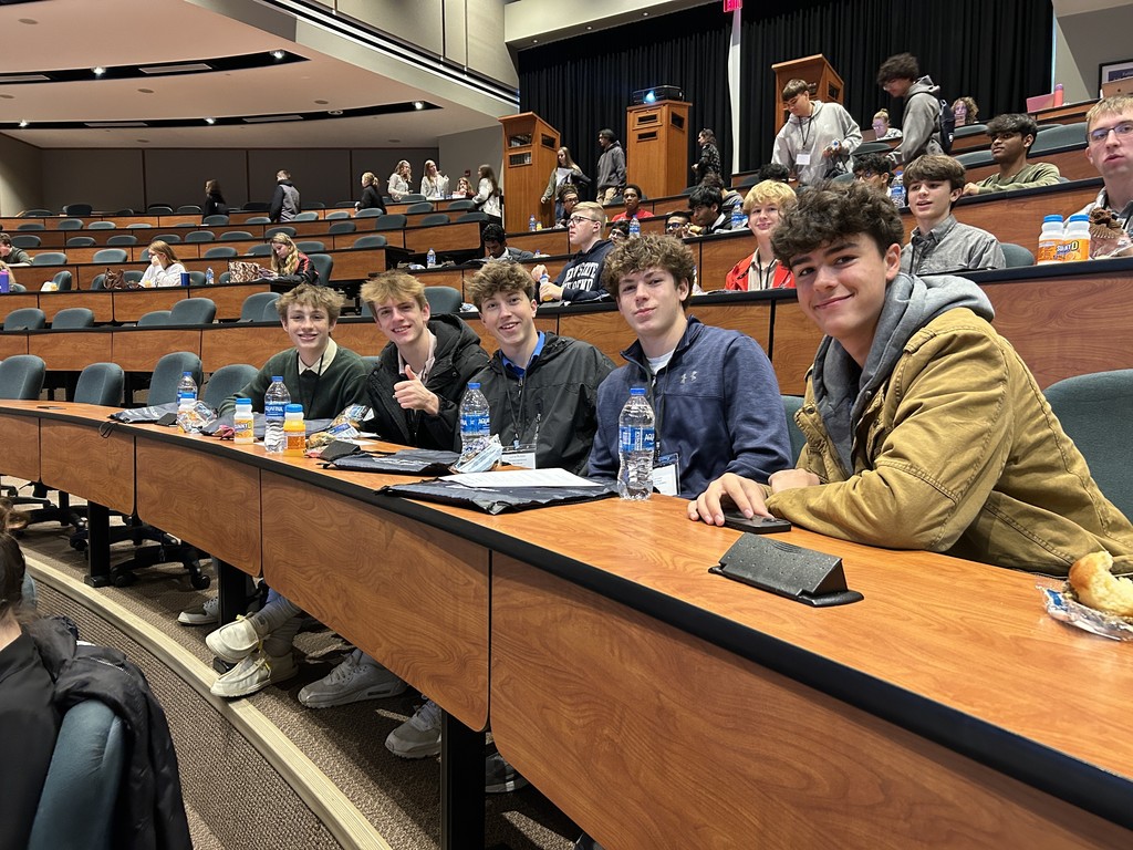 9 students sitting in a conference room