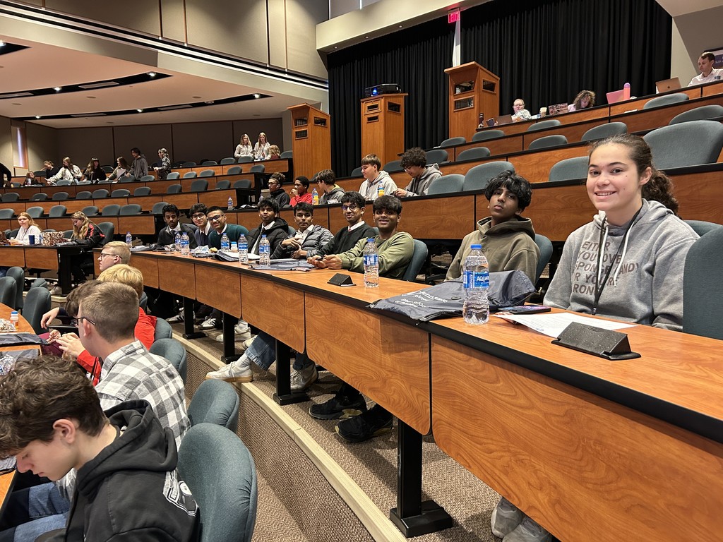 9 students sitting in a conference room