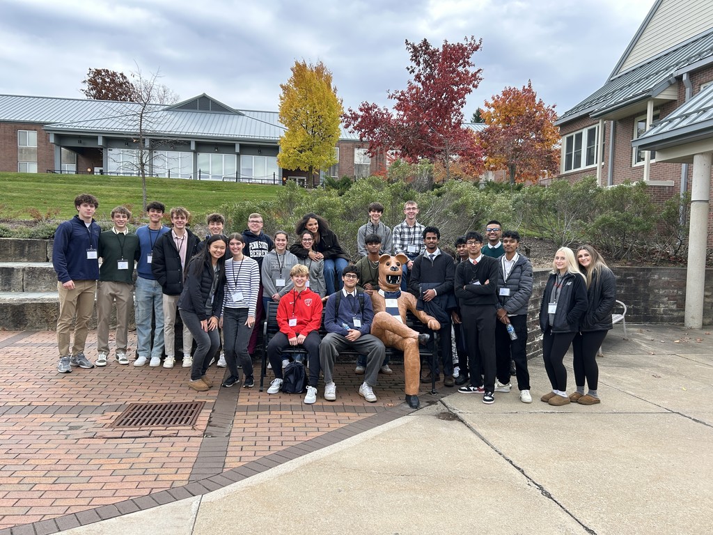 group of students sitting with the Penn State lion