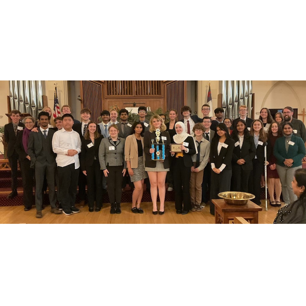 group of students standing with a trophy.