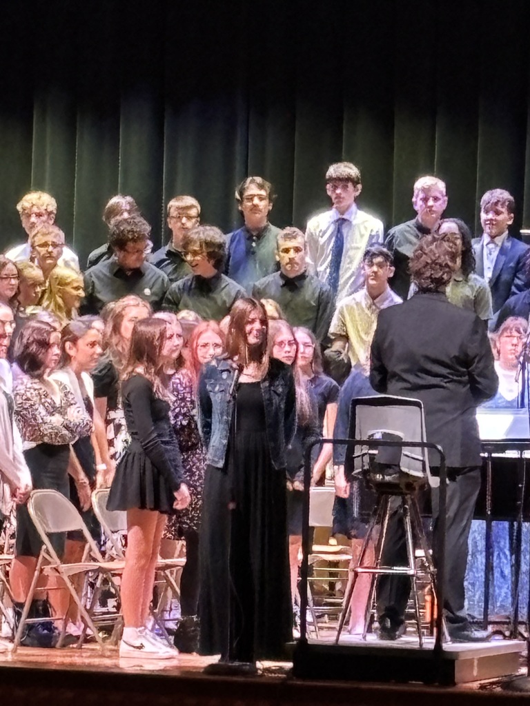 students on stage, one with a solo