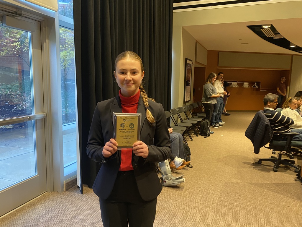 students holding medal