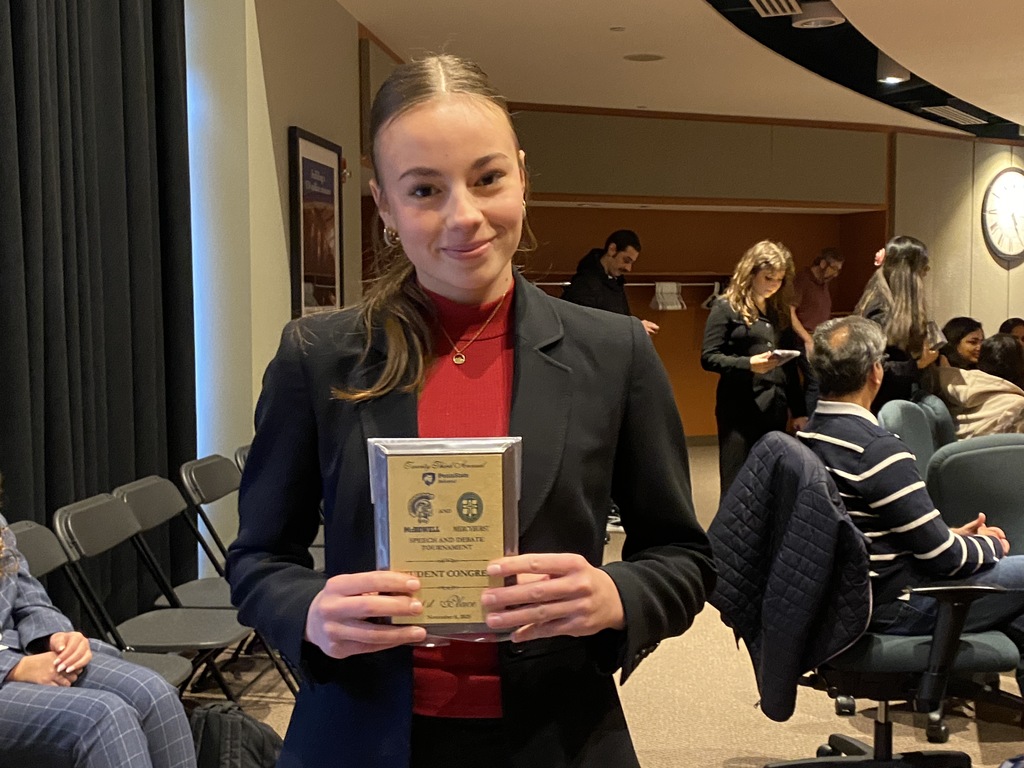 student holding medal