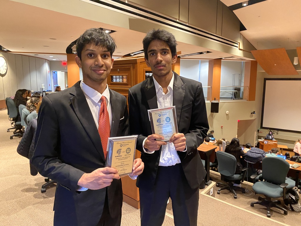 2 students holding medals