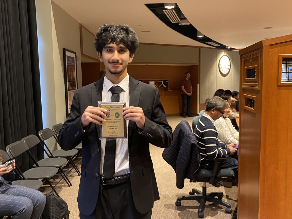 student holding medal