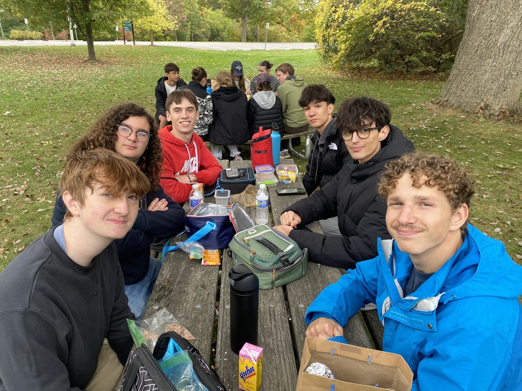 students sitting at picnic tables