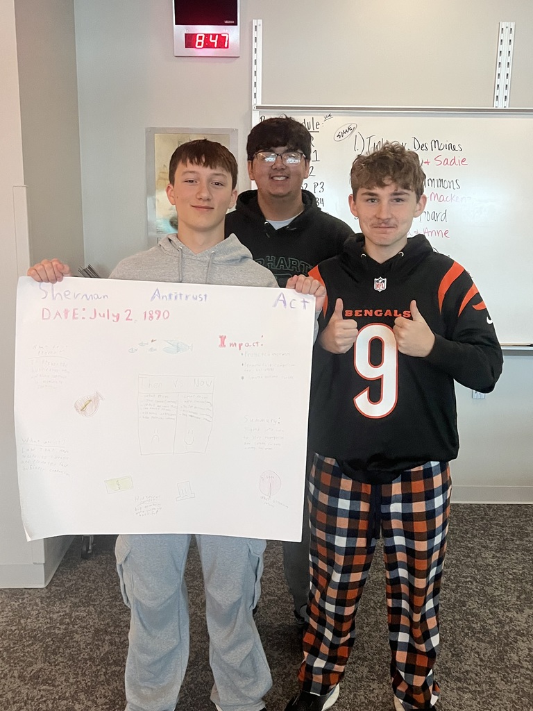 3 students holding poster
