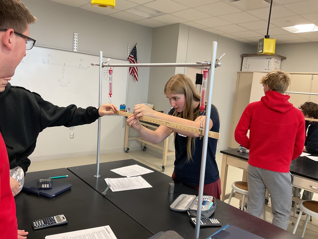 2 students looking on a ruler
