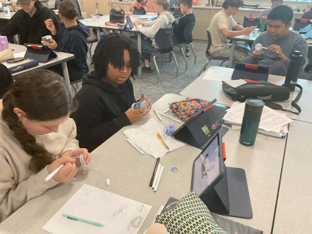 students painting a glass