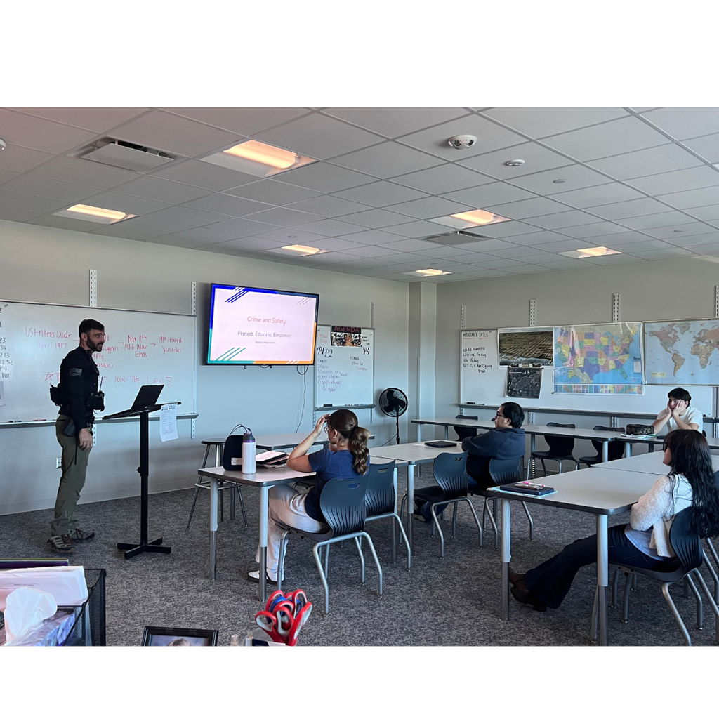 Officer Ras talking in front of the class