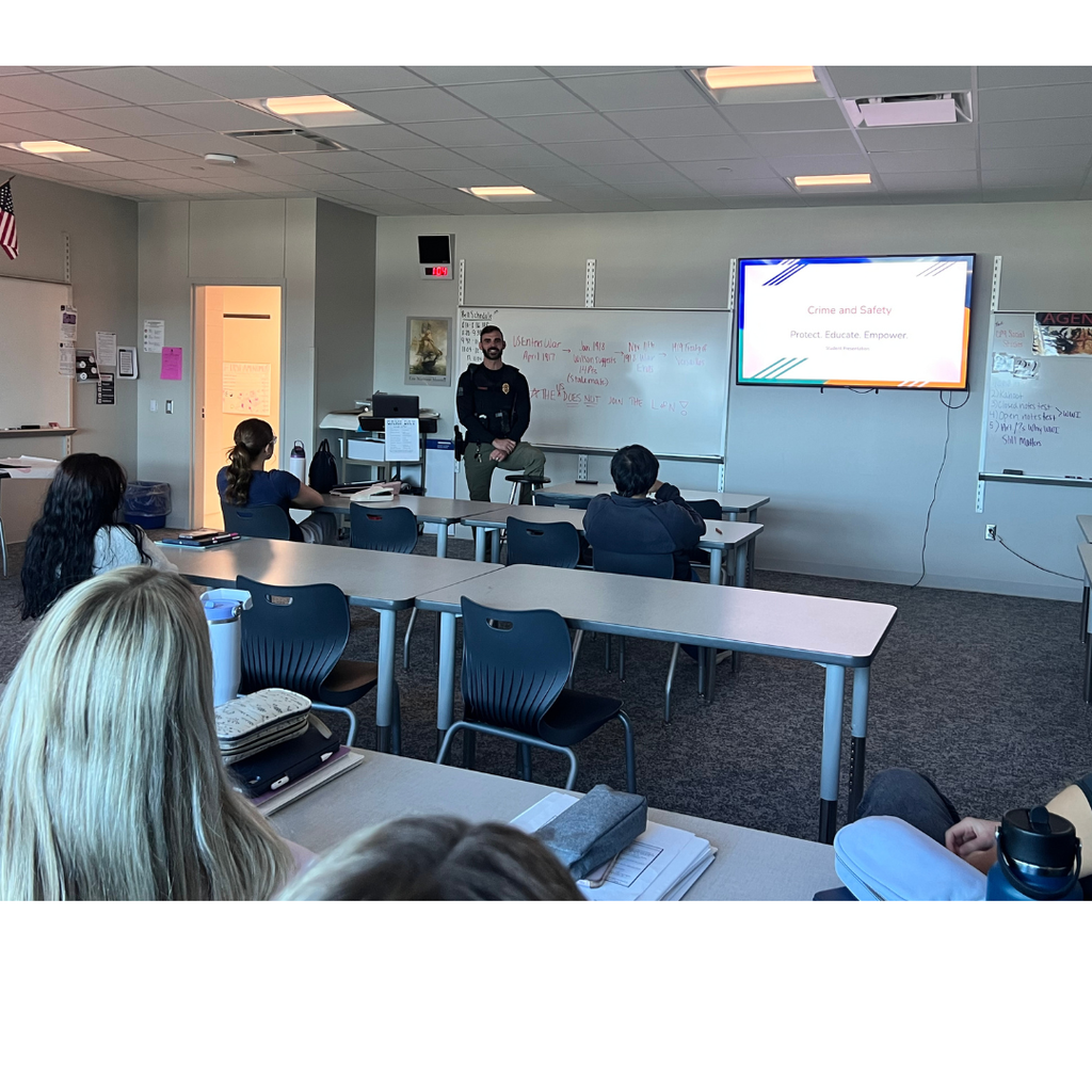 Officer Ras talking in front of the class