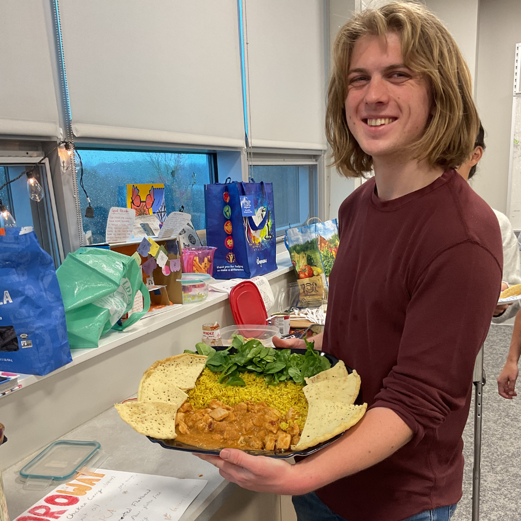 student holding a flag made out of food