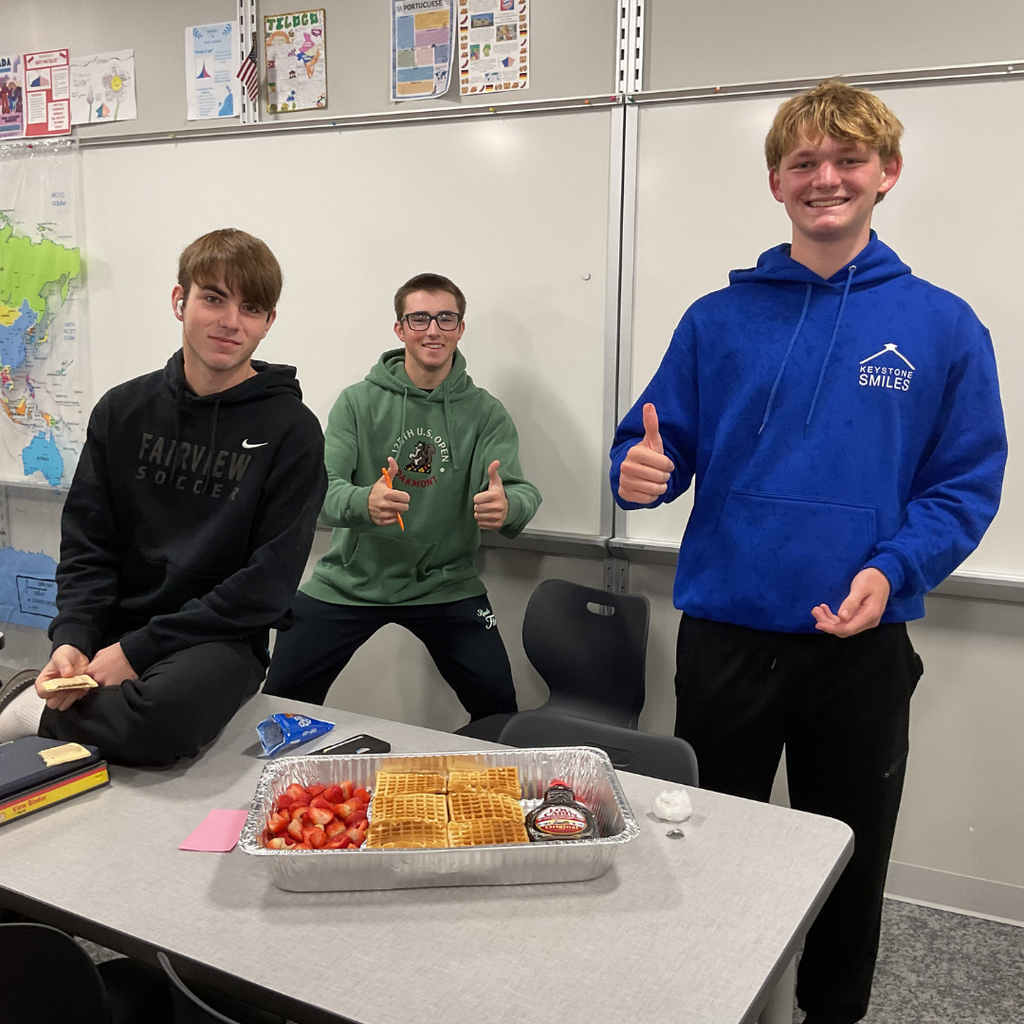 student holding a flag made out of food