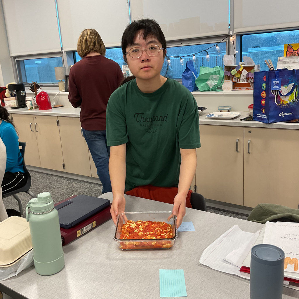 student holding a flag made out of food