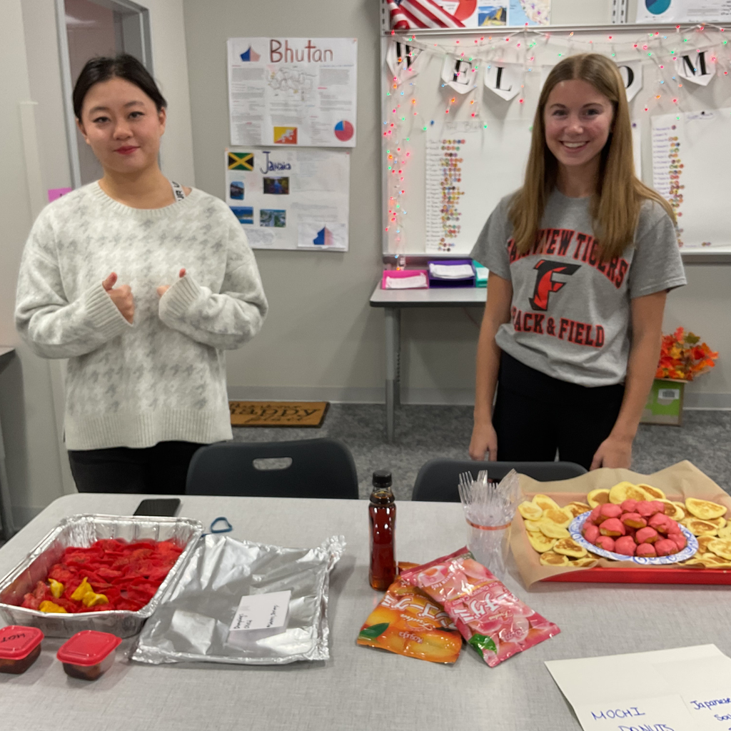 student holding a flag made out of food