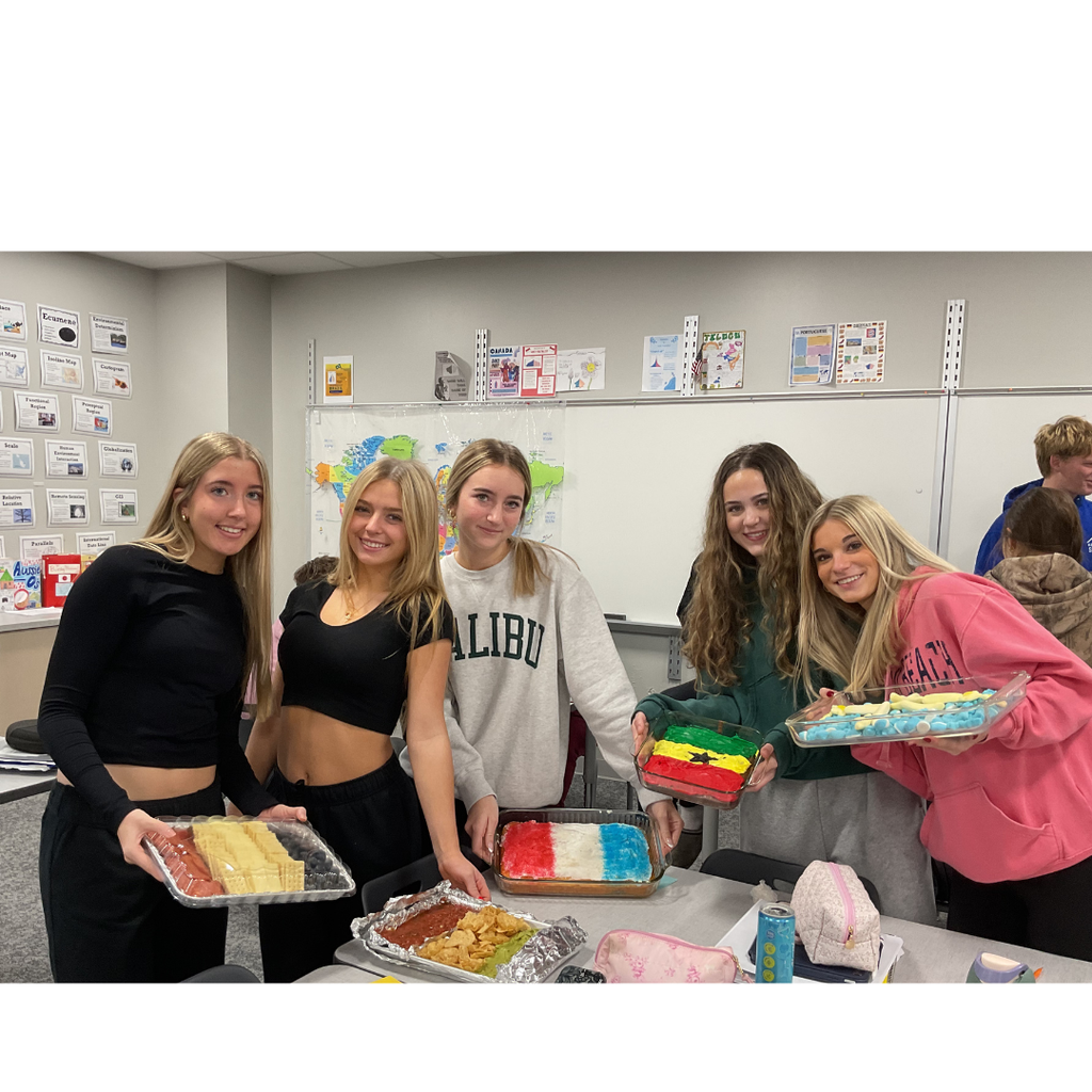 student holding a flag made out of food