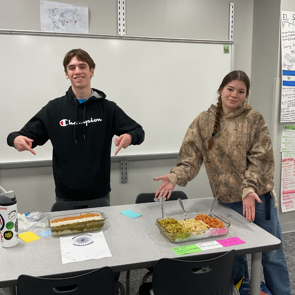 student holding a flag made out of food