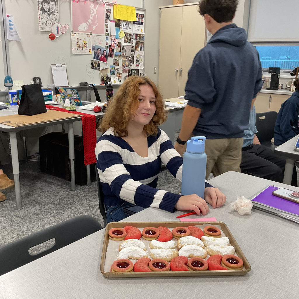 student holding a flag made out of food