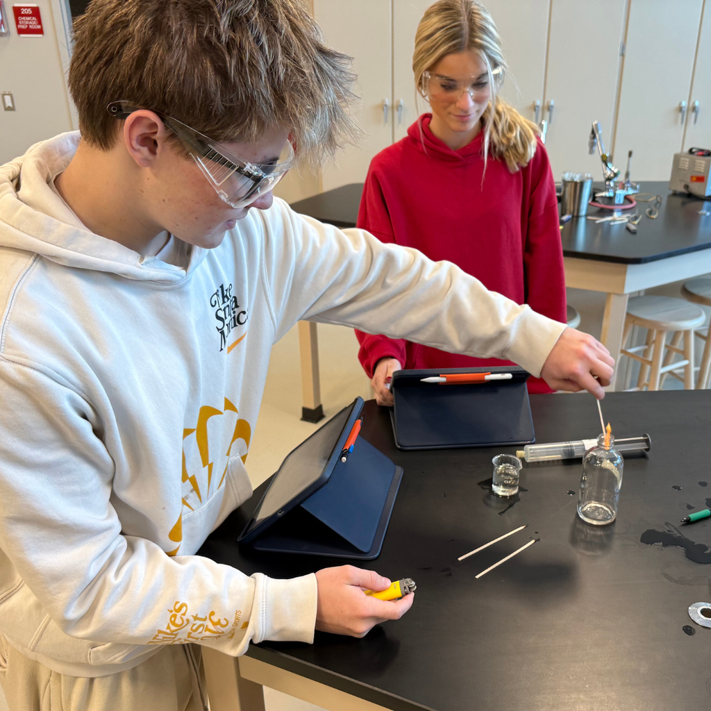 2 students running small-scale reactions