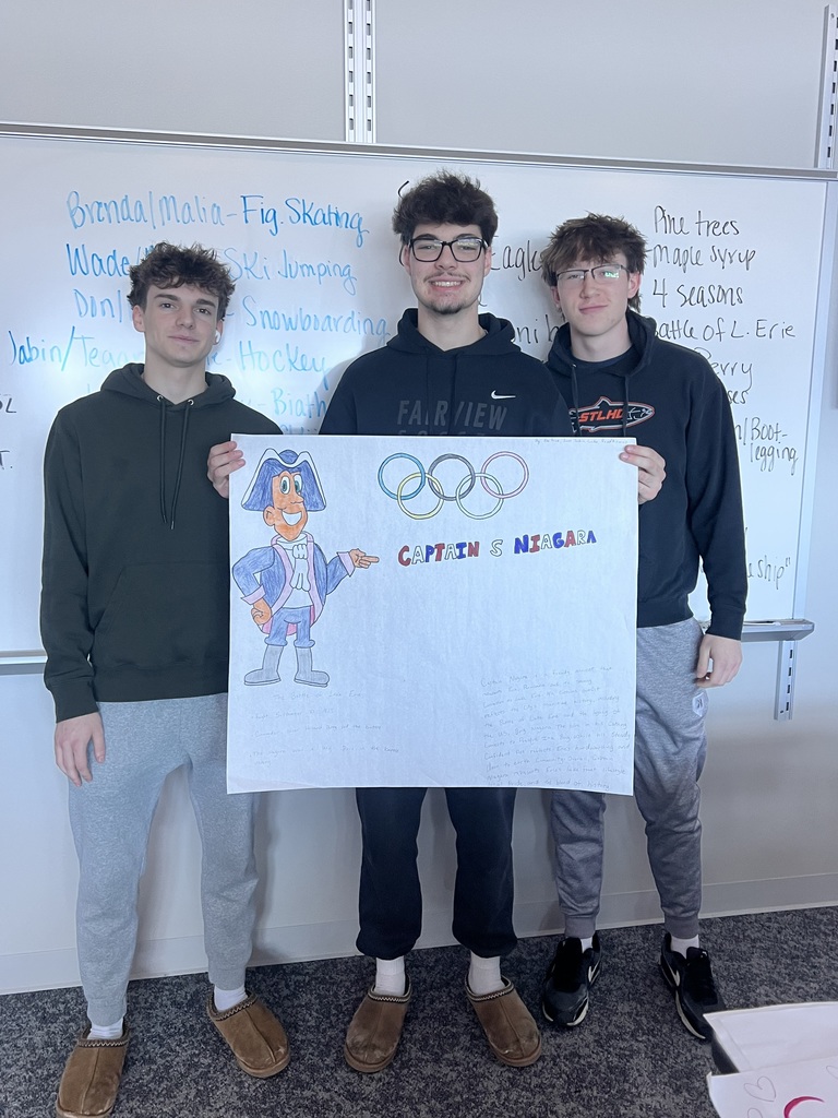 3 students holding a poster