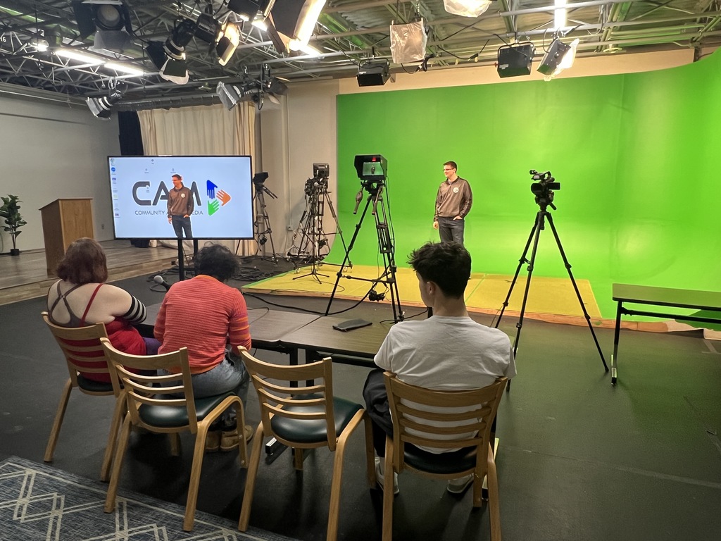 students in front of a green screen