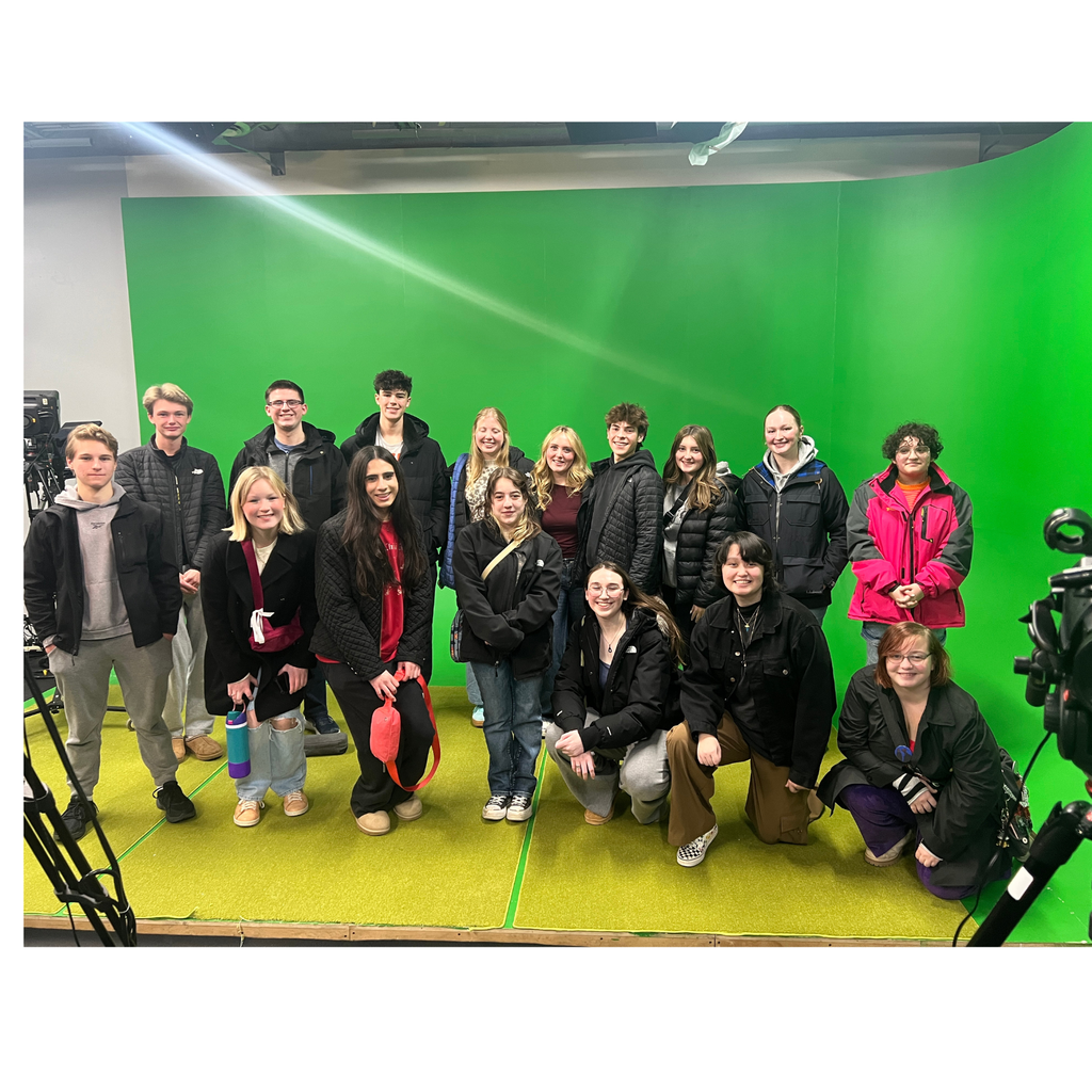 students in front of a green screen