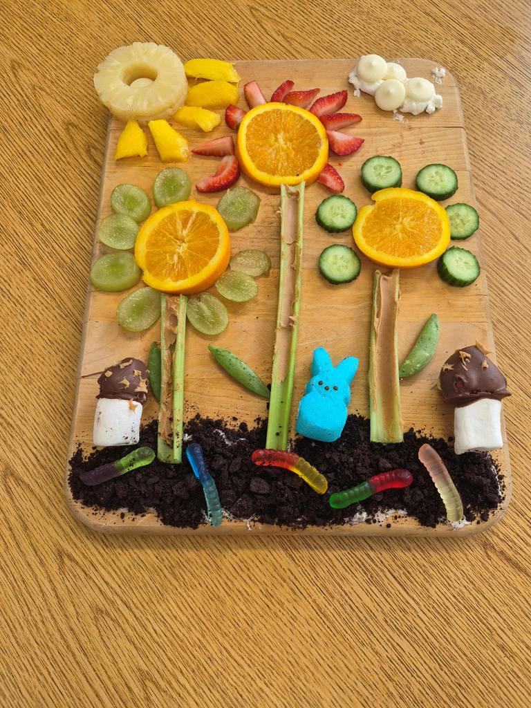Cutting board with fruits arranged as flowers