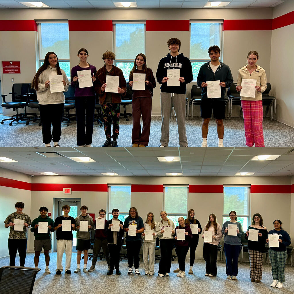students holding papers