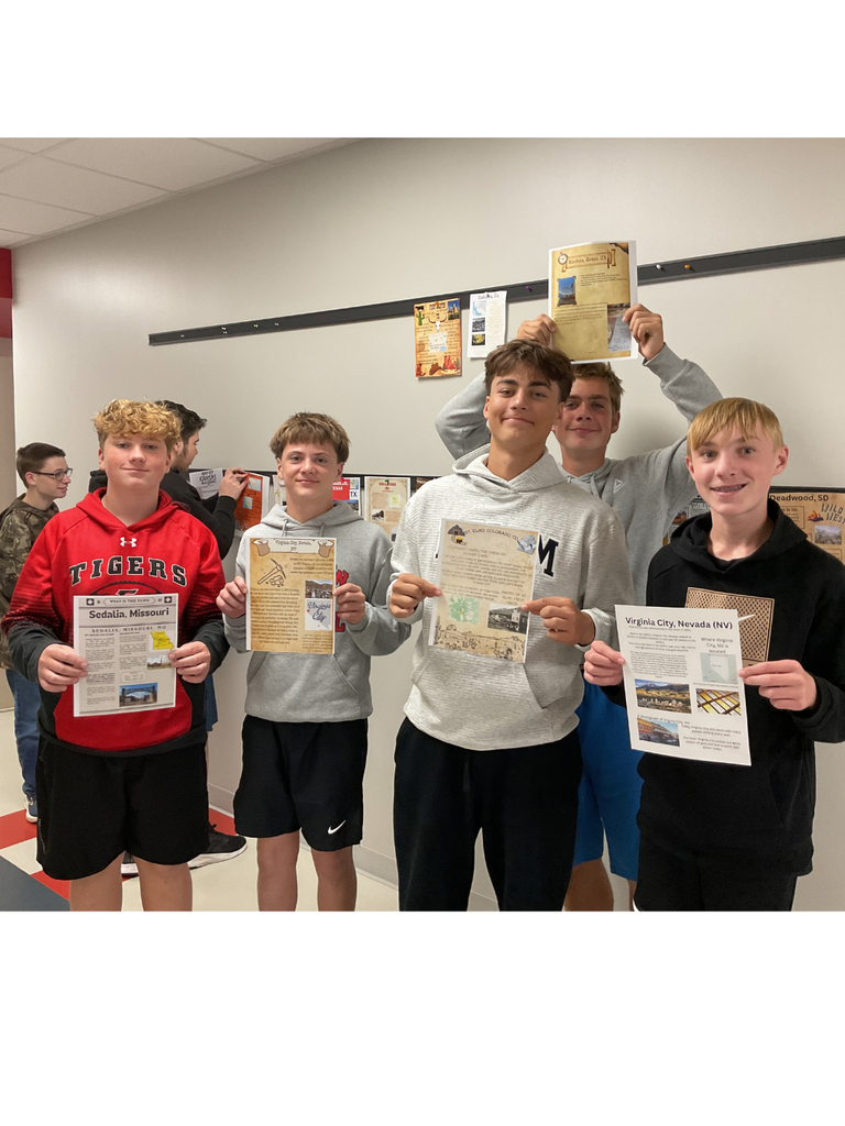 students holding folders
