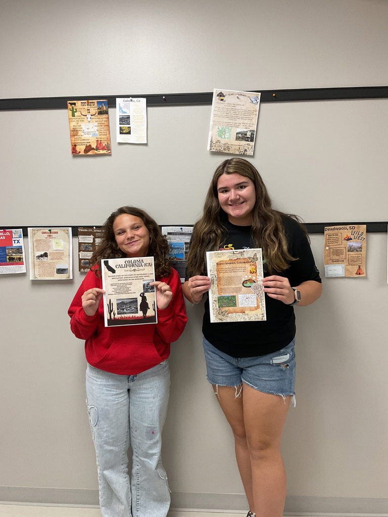 students holding folders